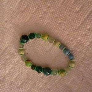 Beaded green bracelet with polymer clay spacers